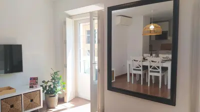 a mirror hanging on a wall in a living room at Sherryflat C/Larga in Jerez de la Frontera