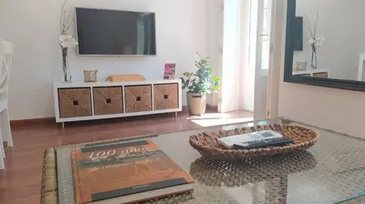 a living room with a tv and a coffee table at Sherryflat C/Larga in Jerez de la Frontera