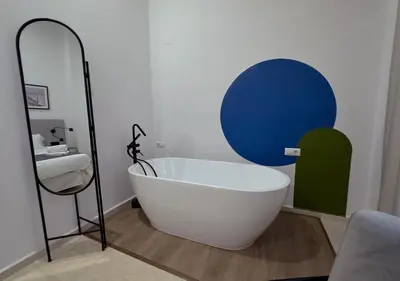 a bath tub in a bathroom with a mirror at ISA Cádiz Palacio de Congresos in Cádiz