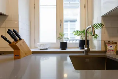 a kitchen with a sink and a knife block at The QUEEN's Designer Apartment by Cadiz4Rentals in Cádiz
