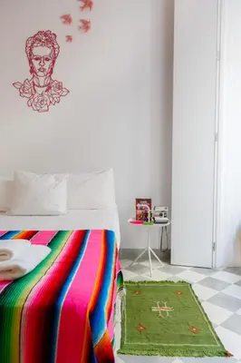 a bedroom with a bed with a colorful blanket at The QUEEN's Designer Apartment by Cadiz4Rentals in Cádiz