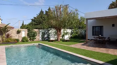 a swimming pool in the backyard of a house at Falsa Pimienta - Sólo Familias y Parejas in Conil de la Frontera