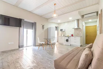 a living room with a couch and a table at Allo Apartments Plateros Centro Jacuzzi Comunitario in Jerez de la Frontera