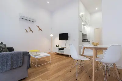 a living room with a couch and a table and chairs at Apartamento Las 3 Gaviotas in Cádiz