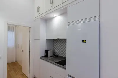 a kitchen with white cabinets and a stove top oven at Apartamento Las 3 Gaviotas in Cádiz