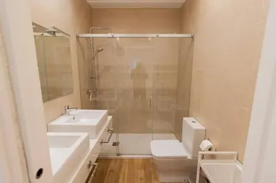 a bathroom with a shower and a toilet and a sink at Apartamento Las 3 Gaviotas in Cádiz
