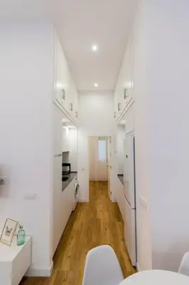 a white apartment with white walls and wooden floors at Apartamento Las 3 Gaviotas in Cádiz