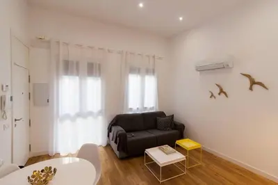 a living room with a couch and a table at Apartamento Las 3 Gaviotas in Cádiz