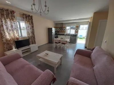 a living room with two couches and a table at Casa Los Naranjos 3 in Cádiz