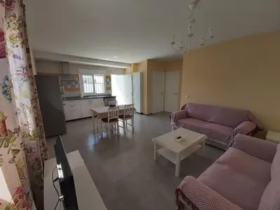 a living room with a couch and a table at Casa Los Naranjos 3 in Cádiz