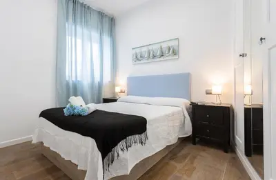 a white bedroom with a bed and a window at Doña Blanca Centro Diseño Minimalista in Jerez de la Frontera