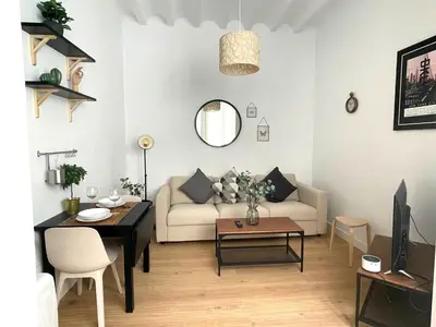 a living room with a couch and a table at La Galería de Botica in Cádiz