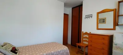 a bedroom with a bed and a dresser and a mirror at Primera línea de playa casita adosada in Chiclana de la Frontera