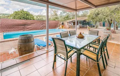 a patio with a table and chairs and a pool at Beautiful Home In Arcos De La Frontera in Arcos de la Frontera