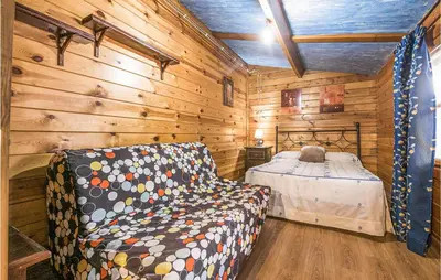 a bedroom with a bed in a wooden cabin at Beautiful Home In Arcos De La Frontera in Arcos de la Frontera