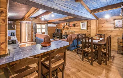a kitchen and dining room in a log cabin at Beautiful Home In Arcos De La Frontera in Arcos de la Frontera