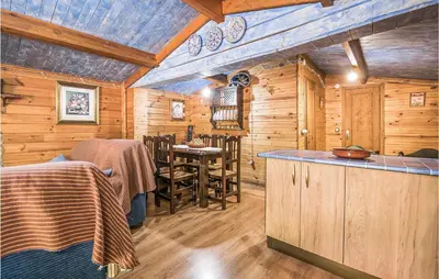 a log cabin kitchen with a bar and a table at Beautiful Home In Arcos De La Frontera in Arcos de la Frontera