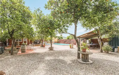 a backyard with a pool and trees and a house at Beautiful Home In Arcos De La Frontera in Arcos de la Frontera
