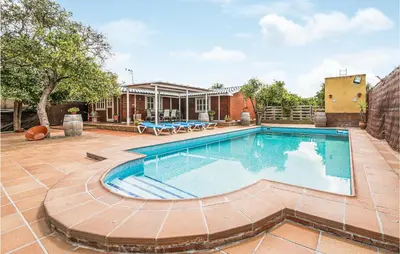a swimming pool in a yard with a house at Beautiful Home In Arcos De La Frontera in Arcos de la Frontera