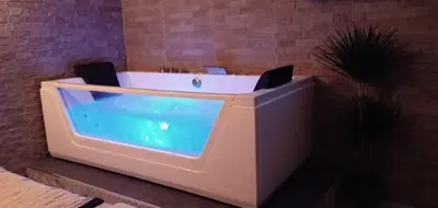 a bath tub in a bathroom with a swimming pool at ESTUDIO Jacuzzi SOL De JEREZ in Jerez de la Frontera