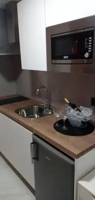 a kitchen counter with a plate with wine glasses on it at ESTUDIO Jacuzzi SOL De JEREZ in Jerez de la Frontera