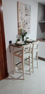 a table and chairs with a vase on top of it at ESTUDIO Jacuzzi SOL De JEREZ in Jerez de la Frontera