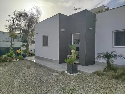 a house with a black and white facade at EL ATARDECER in Conil de la Frontera