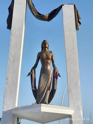a statue of a woman with her arms outstretched at Chipiona Santuario de Regla Playa Bajo A in Chipiona