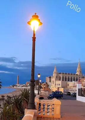 a street light with a building in the background at Chipiona Santuario de Regla Playa Bajo A in Chipiona