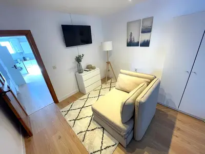 a living room with a couch and a television at El Ático de Botica in Cádiz
