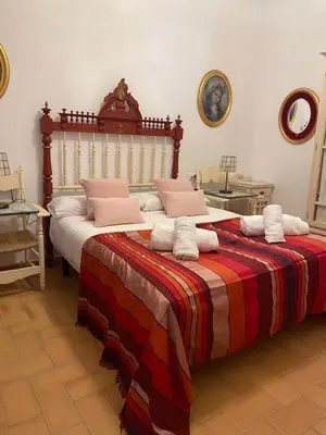 a bedroom with two beds with pillows on them at Loft en casa Palacio Mergelina Parking gratis in Sanlúcar de Barrameda