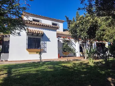 a white house with a window and a yard at The Magic House in El Puerto de Santa María