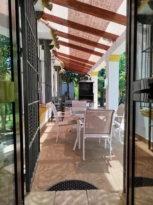 a patio with chairs and a table and a television at The Magic House in El Puerto de Santa María