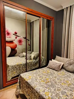 a bedroom with a mirror and a bed and a bed sidx sidx sidx at The Magic House in El Puerto de Santa María