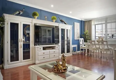 a living room with a large white entertainment center at Caprichos in Jerez de la Frontera