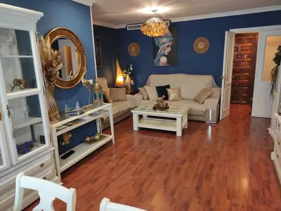 a living room with blue walls and a couch at Caprichos in Jerez de la Frontera