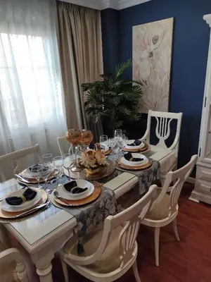 a dining room table with plates of food on it at Caprichos in Jerez de la Frontera