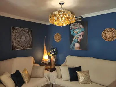 a living room with two couches and a chandelier at Caprichos in Jerez de la Frontera