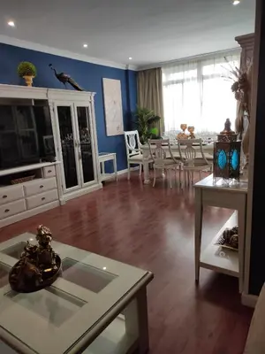 a living room with a table and a dining room at Caprichos in Jerez de la Frontera