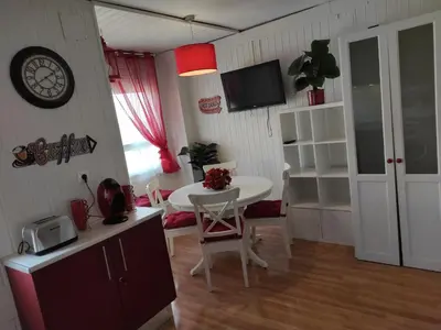 a kitchen with a table and a small table and a room at Caprichos in Jerez de la Frontera