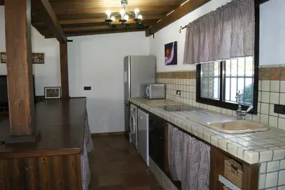 a kitchen with a sink and a refrigerator at EL ALAZAN in Chiclana de la Frontera