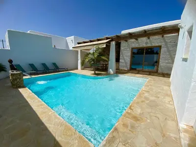 a swimming pool in the backyard of a house at TURQUETA in Chiclana de la Frontera