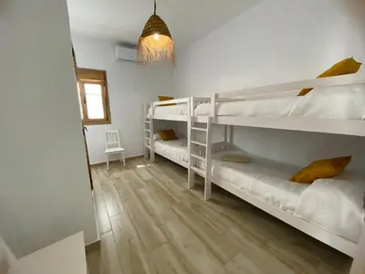a room with two bunk beds and a hallway at TURQUETA in Chiclana de la Frontera
