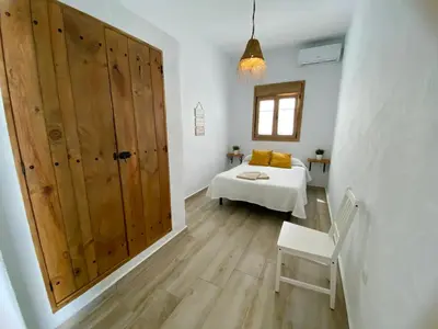 a room with a large wooden door and a bed at TURQUETA in Chiclana de la Frontera