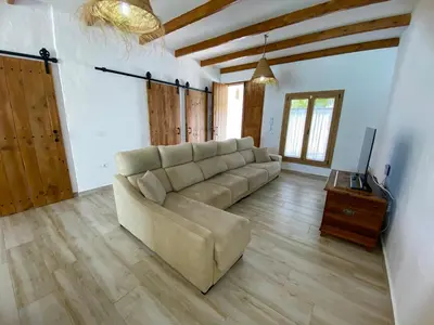a living room with a couch and a television at TURQUETA in Chiclana de la Frontera