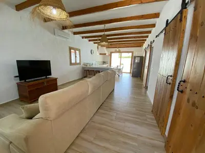 a living room with a couch and a television at TURQUETA in Chiclana de la Frontera