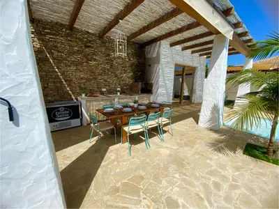 a patio with a table and chairs and a fireplace at TURQUETA in Chiclana de la Frontera