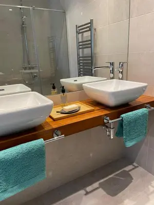 a bathroom with two white sinks and a mirror at LyriosHomes Luxury Costa Ballena Beach in Chipiona
