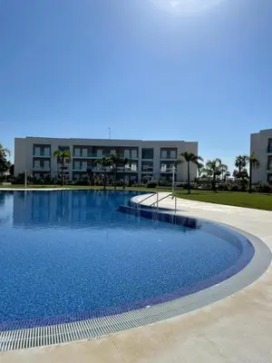 a large swimming pool in front of a building at LyriosHomes Luxury Costa Ballena Beach in Chipiona
