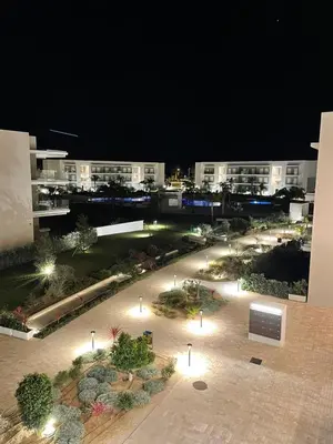 a view of a courtyard at night with buildings at LyriosHomes Luxury Costa Ballena Beach in Chipiona